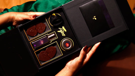 TIPS luxury chocolate foreplay hamper – a premium black and gold box featuring sensual chocolates, AURA seductive perfume, a silky blindfold, and the Shab-e-Raz intimacy guide for an unforgettable night of passion.